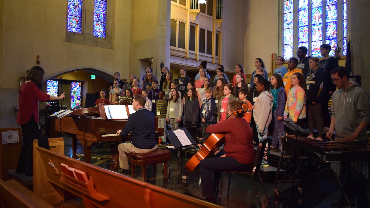 CCM rehearses as part of a local 4-choir festival to benefit Blessings In A Backpack